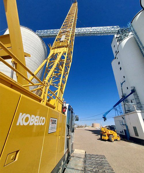 yellow crane on site at a grain elevator
