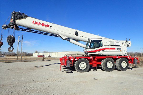 red and white rough terrain crane
