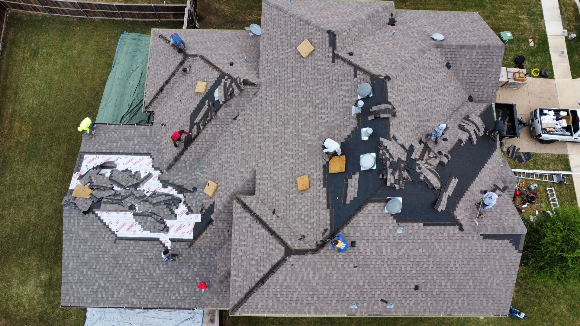 An aerial view of a roof being installed on a house.