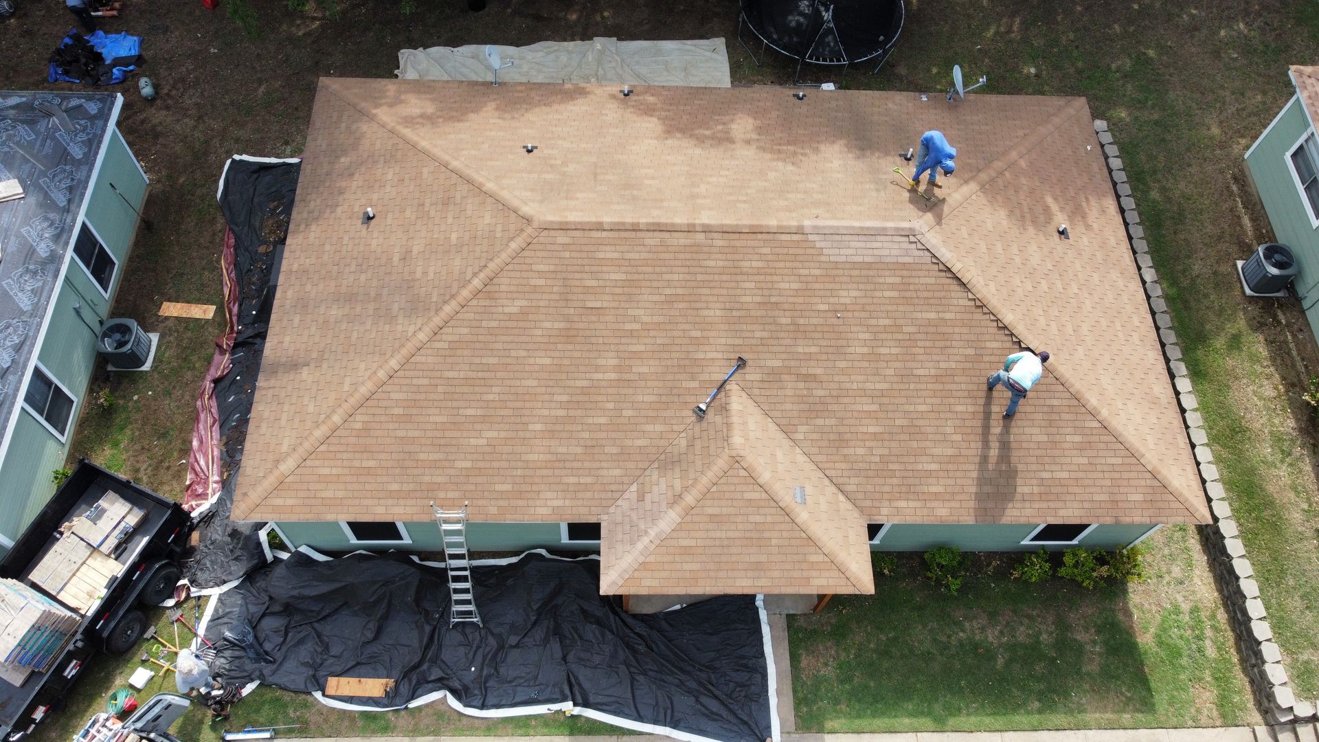 An aerial view of a house with a roof being installed.