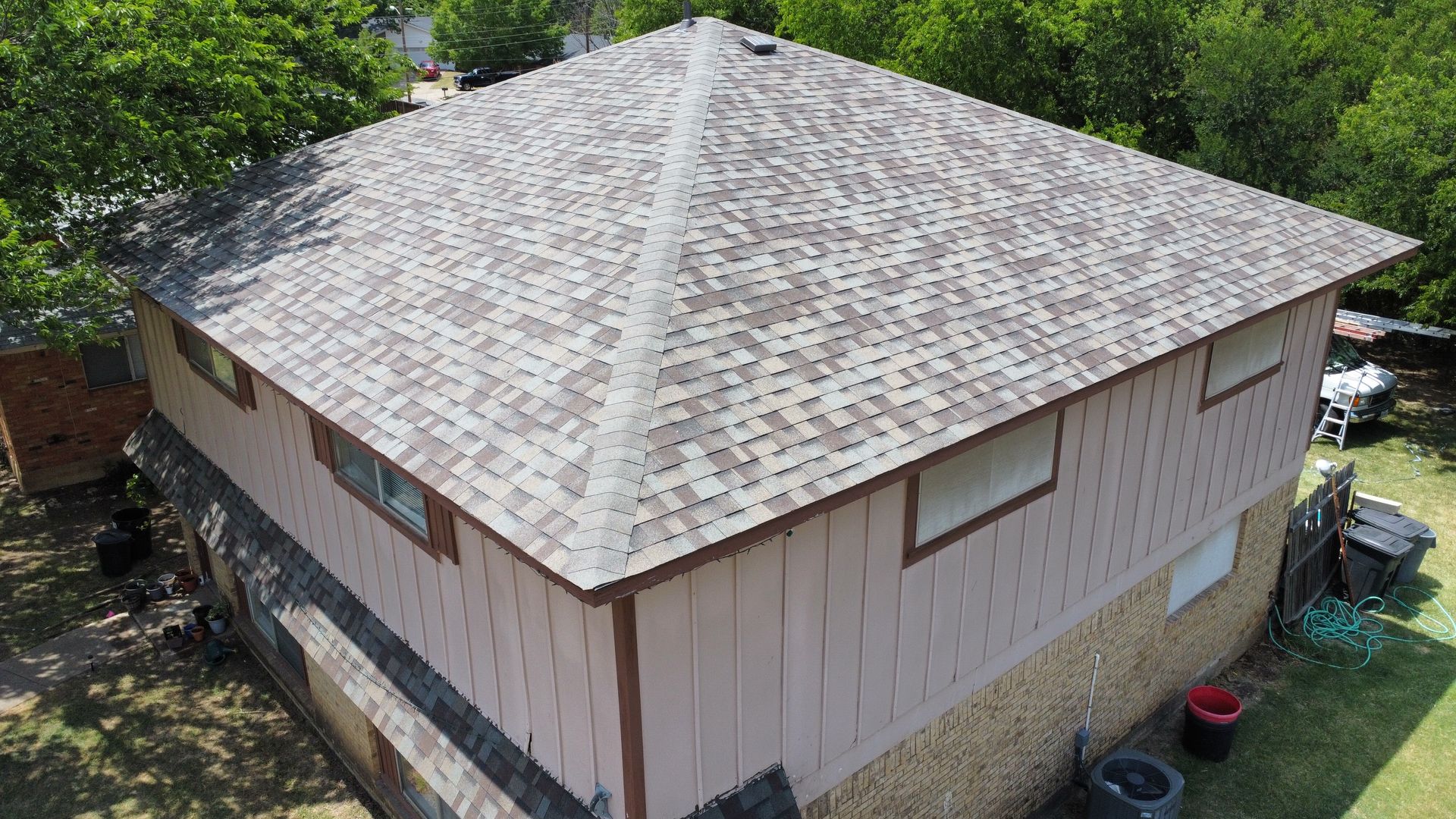 An aerial view of a house with a new roof.