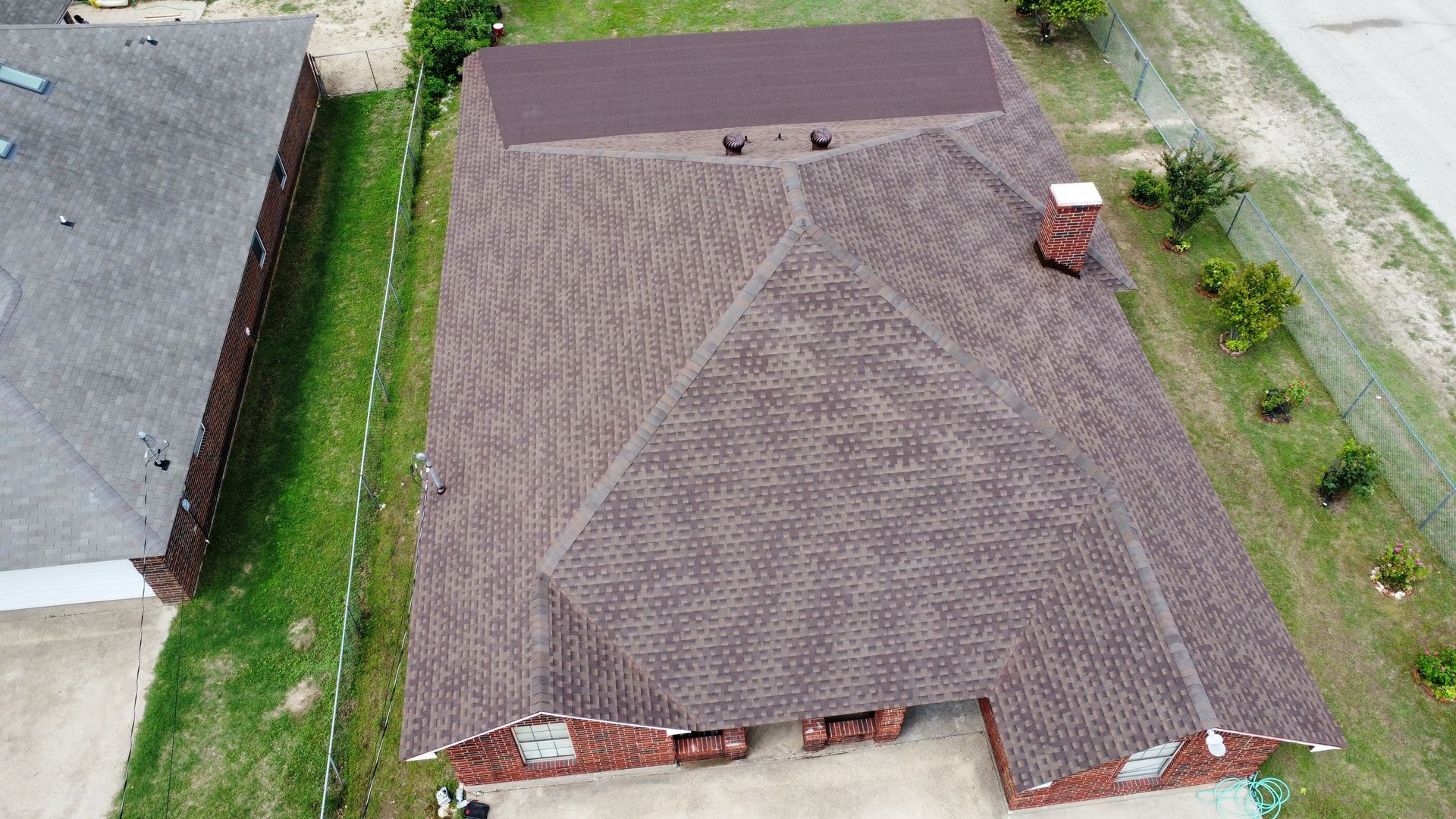 An aerial view of a house with a roof and a chimney.
