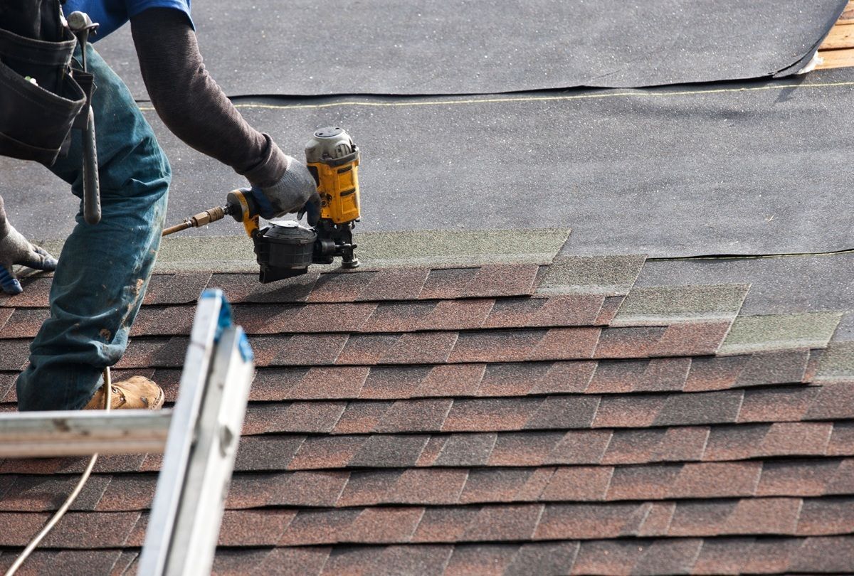 Roofing specialists performing a professional roof replacement in Los Banos