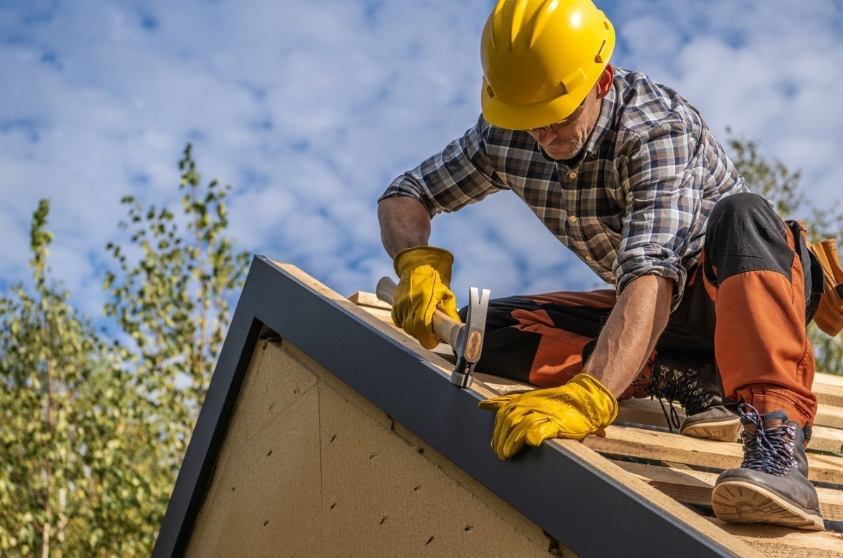 Professional roofer inspecting roofing materials in Atwater