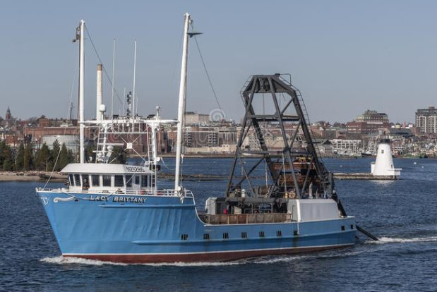 a large blue and white boat is floating on top of a body of water .