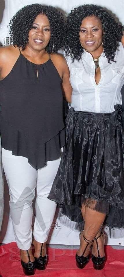 Staci & Traci pose together on a red carpet