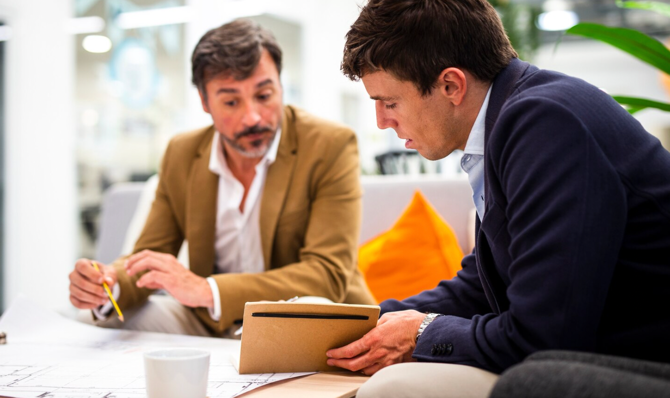 Business team discussing legal and corporate considerations before raising investment capital.