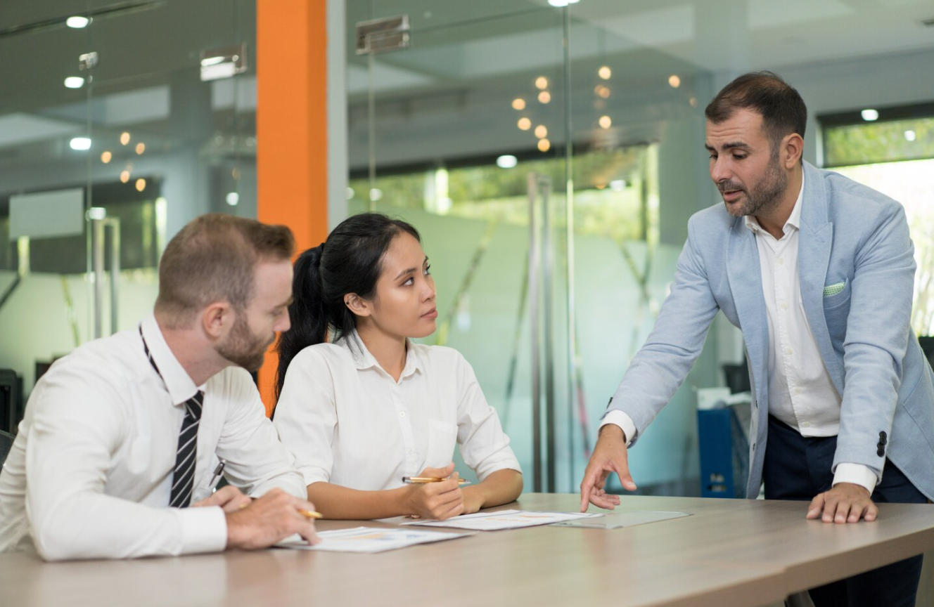 Business clients discussing compliance matters with a corporate lawyer in Los Angeles.