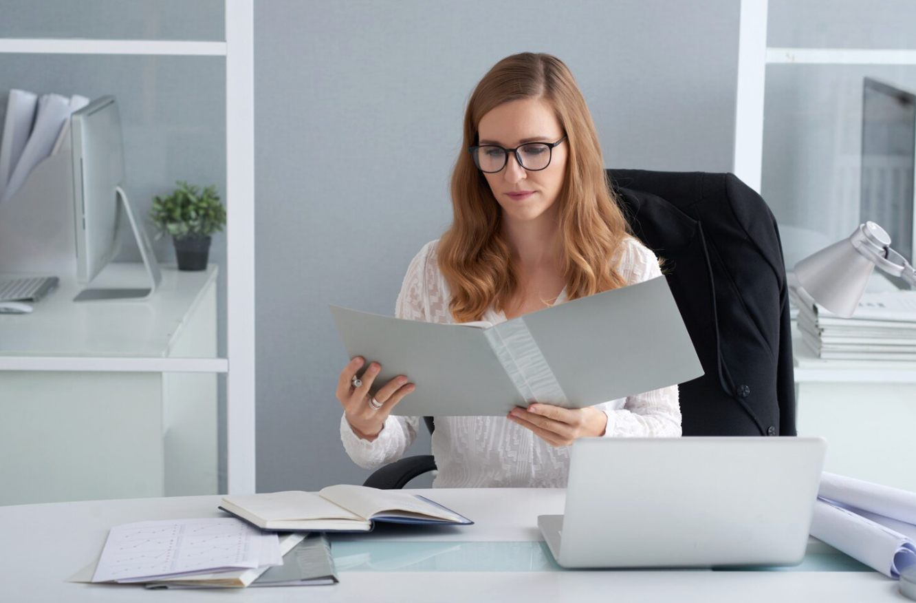 Attorney reviewing business sale documents during the due diligence process before closing a transaction.