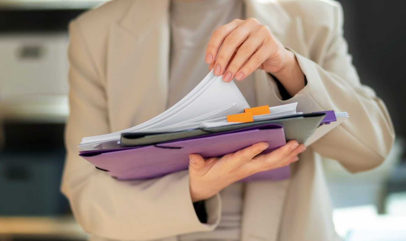 Business owner reviewing corporate and investment documents in preparation for fundraising.