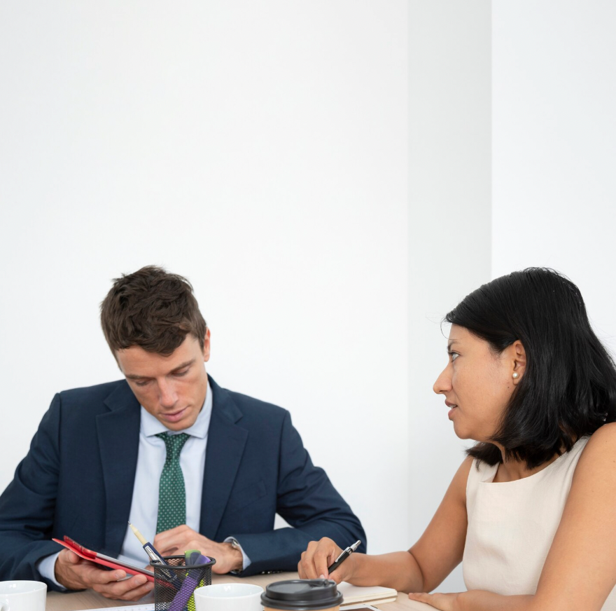 Corporate attorney advising small business owner on intellectual property protection.