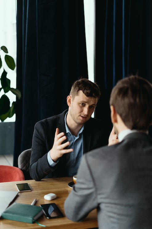 Corporate lawyer advising an entrepreneur during a business consultation.