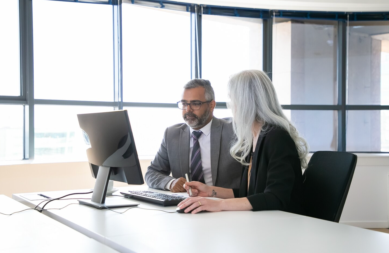 Business professionals discussing AI compliance with a corporate lawyer.