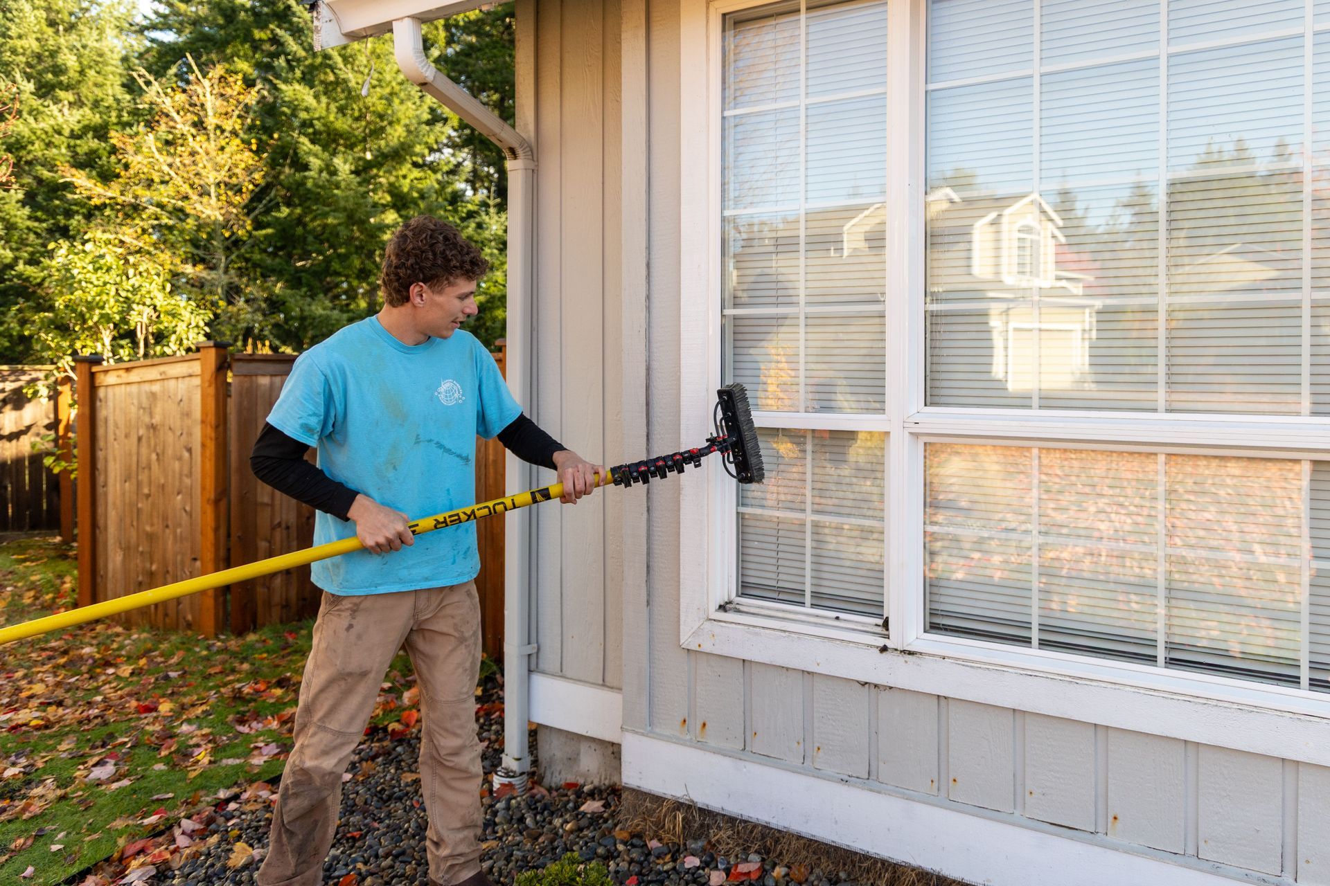 A man is cleaning a window.