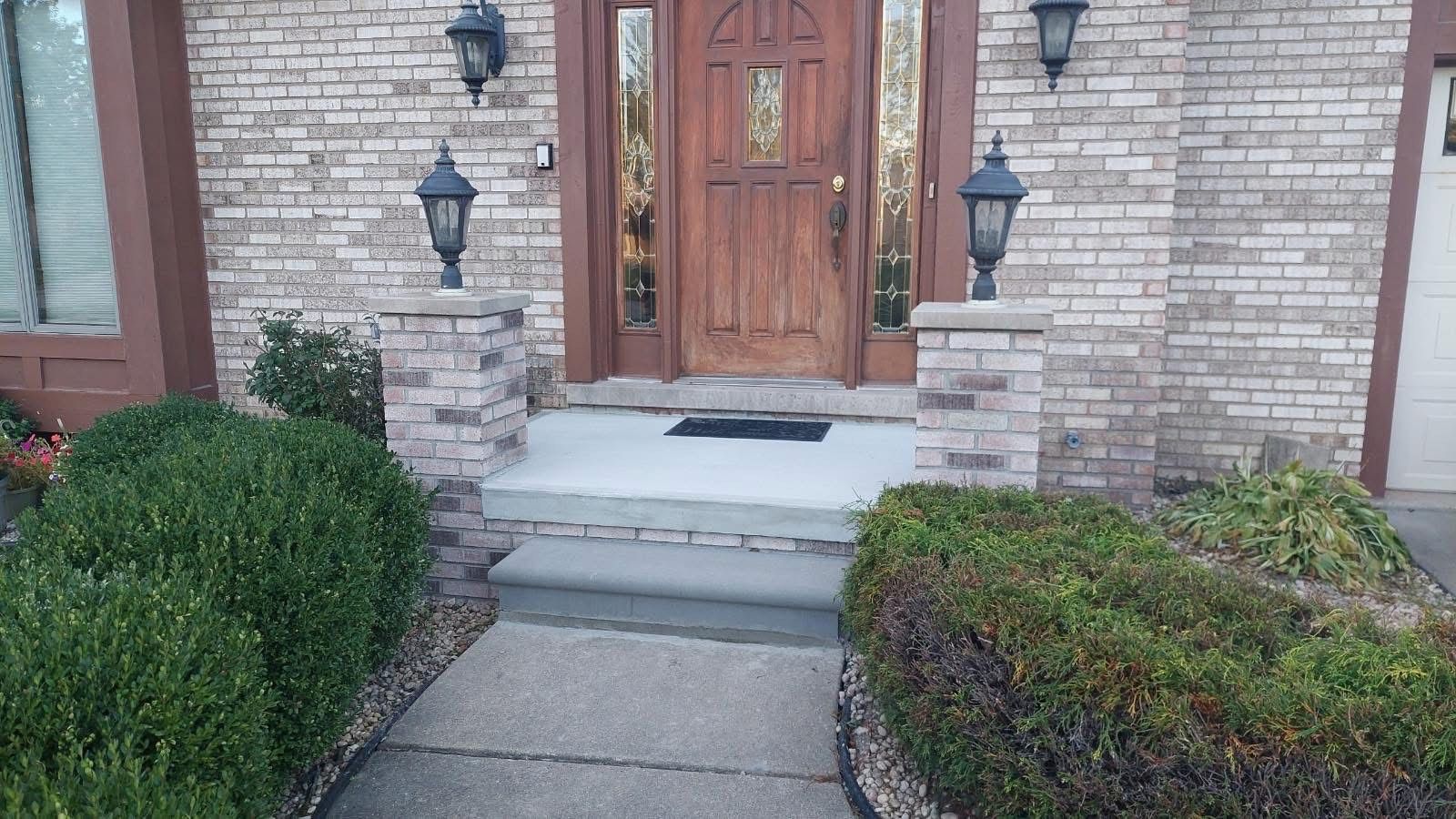 A blue adt sign is sitting next to a set of concrete steps. A blue adt sign is sitting next to a set of concrete steps.