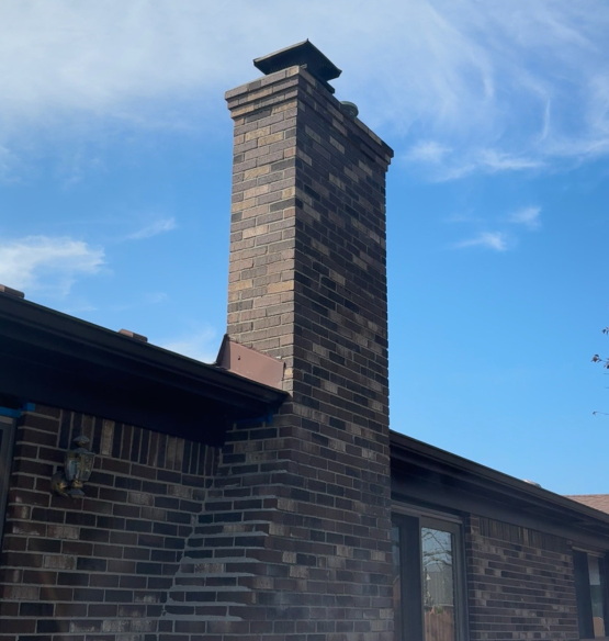 A brick chimney on the side of a house A brick chimney on the side of a house