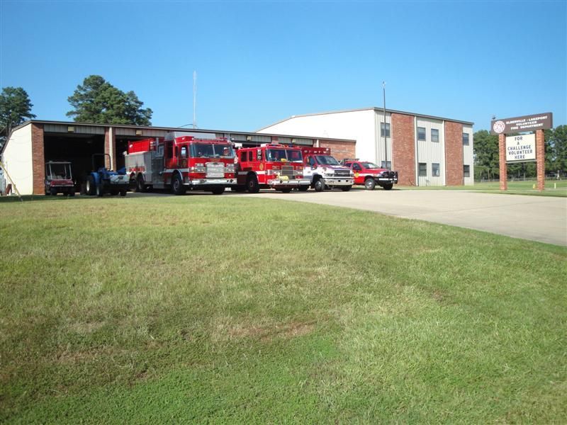 A row of fire trucks parked in front of a building