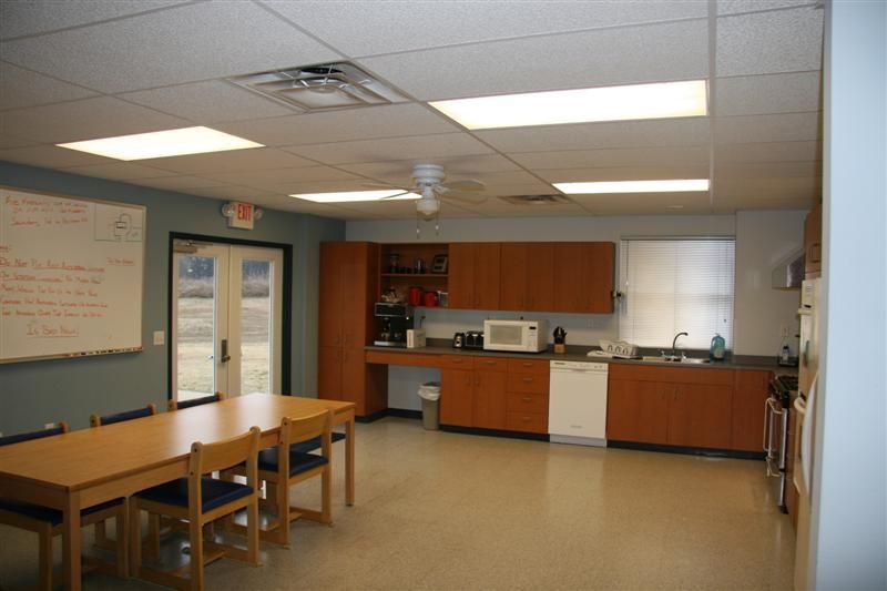 A kitchen with a table and chairs in it