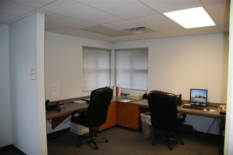 A small office with two desks and two chairs