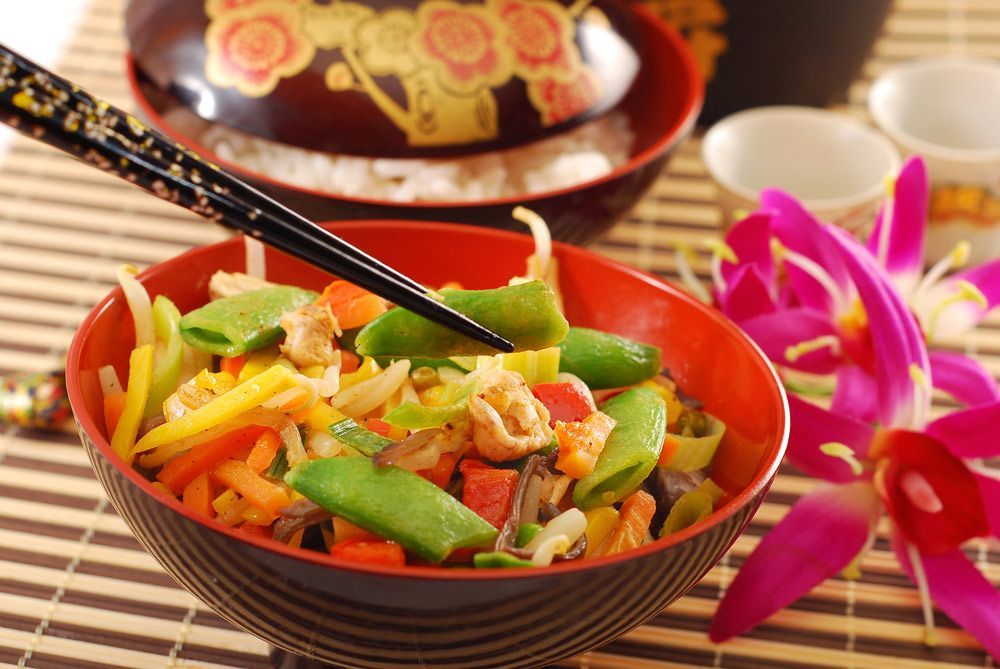 A Bowl Of Vegetables With Chopsticks In It On A Table — One Thai Cuisine & Noodle Bar In Kirwan, QLD