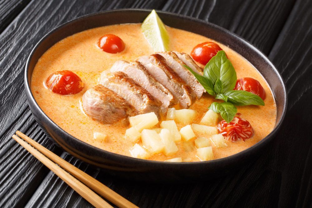 A Close Up Of A Bowl Of Soup With Chopsticks On A Table — One Thai Cuisine & Noodle Bar In Kirwan, QLD