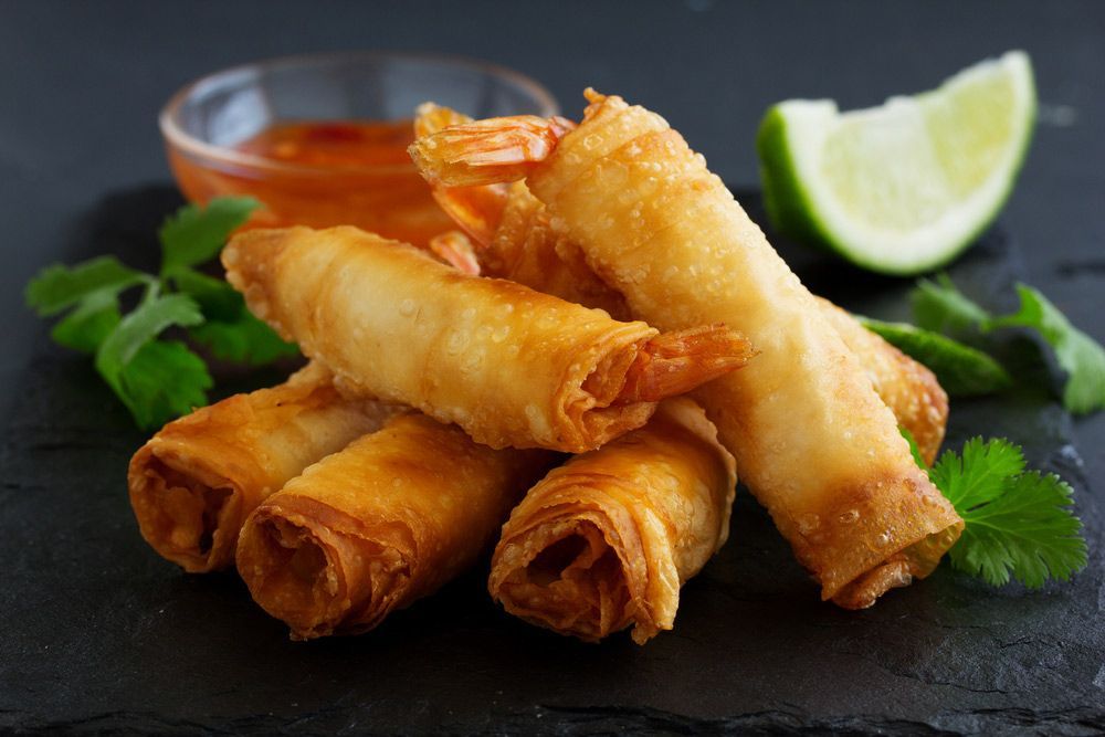 Fried Shrimp Spring Rolls With Sauce And Lime Wedges On A Black Plate — One Thai Cuisine & Noodle Bar In Kirwan, QLD