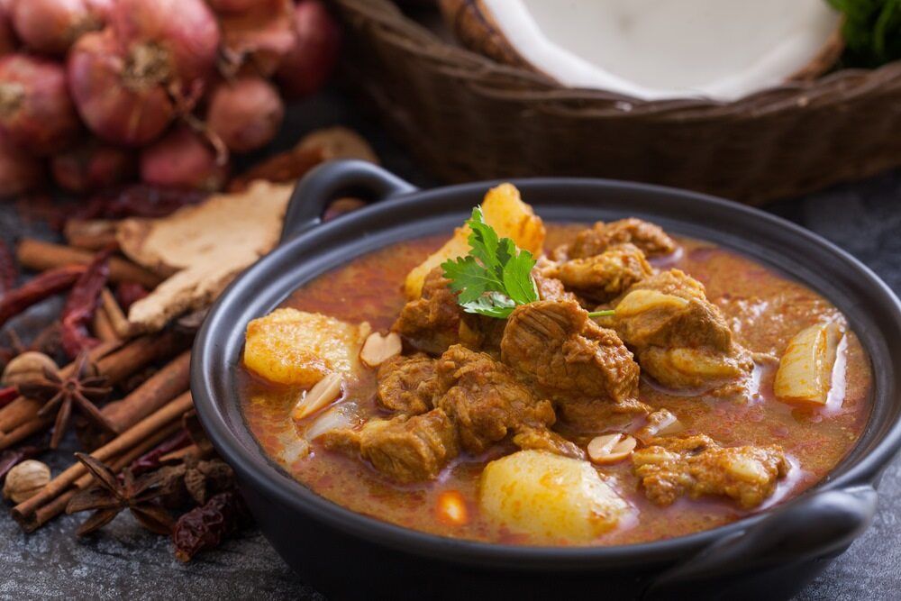 There Is A Bowl Of Curry With Meat And Potatoes In It — One Thai Cuisine & Noodle Bar In Kirwan, QLD
