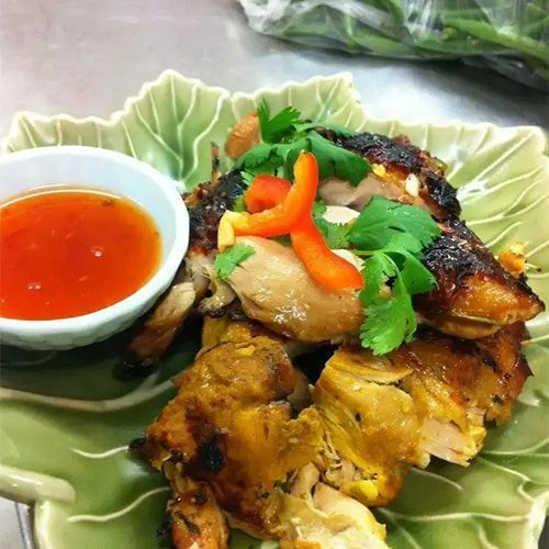 A Plate Of Food With A Small Bowl Of Dipping Sauce — One Thai Cuisine & Noodle Bar In Kirwan, QLD