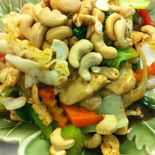 A Close Up Of A Plate Of Food With Cashews And Vegetables — One Thai Cuisine & Noodle Bar In Kirwan, QLD