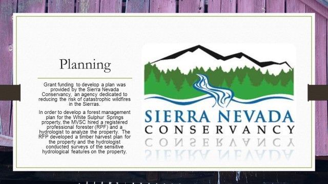 A sierra nevada conservancy sign on a wooden wall
