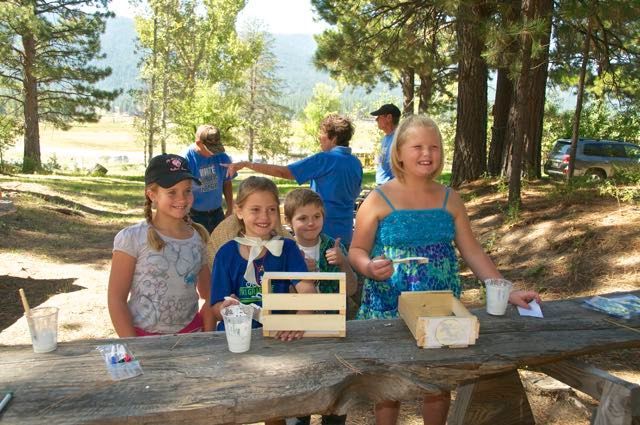 A group of children are sitting at a picnic table