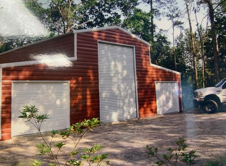 a white truck is parked in front of a red garage