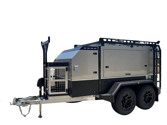 A trailer with a dog cage attached to it on a white background.