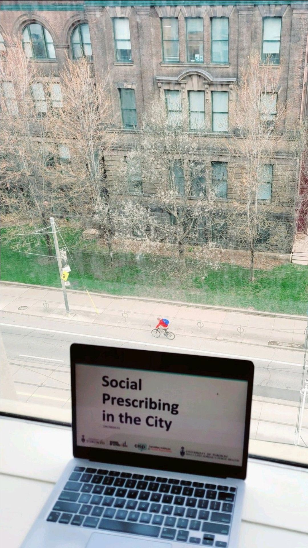 A laptop is open to a screen that says social prescribing in the city.