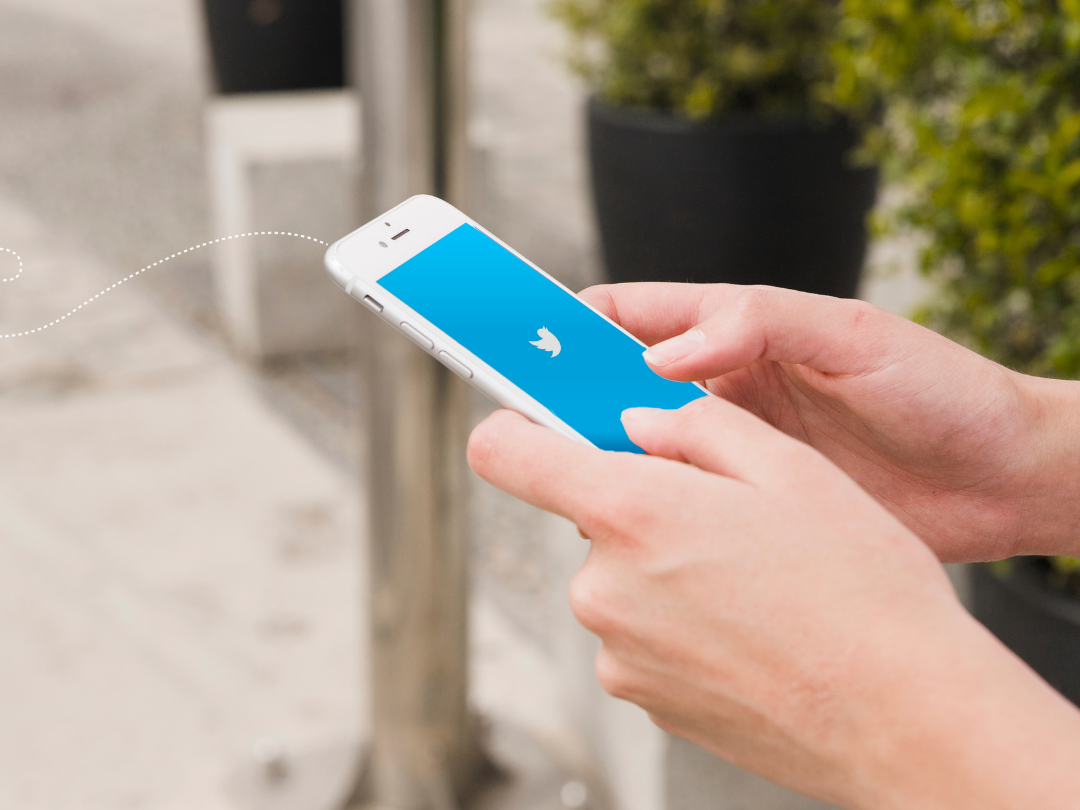 A person is holding a cell phone with a blue screen.