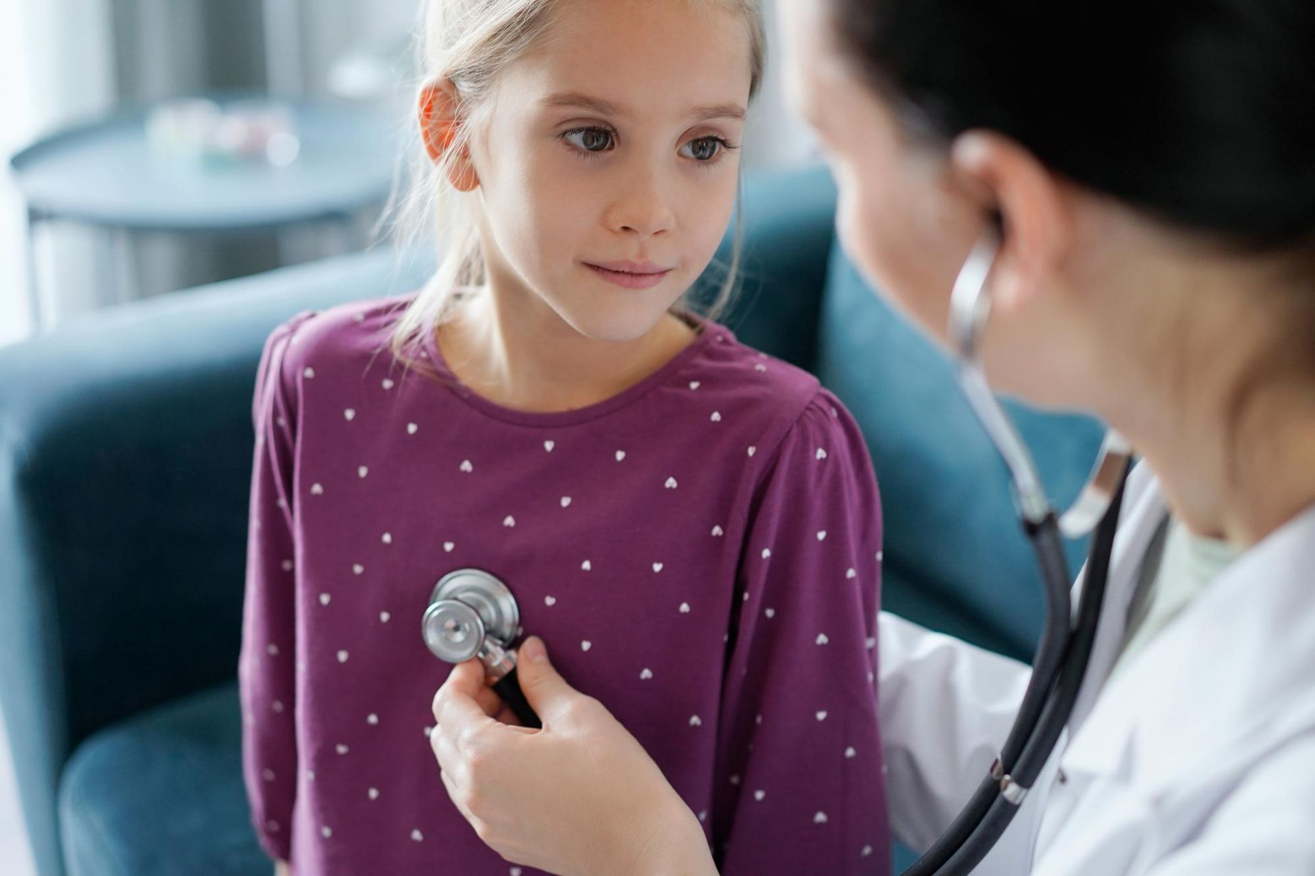 A doctor using a stethoscope on a child, highlighting affordable health insurance options and Mississippi short-term disability coverage.