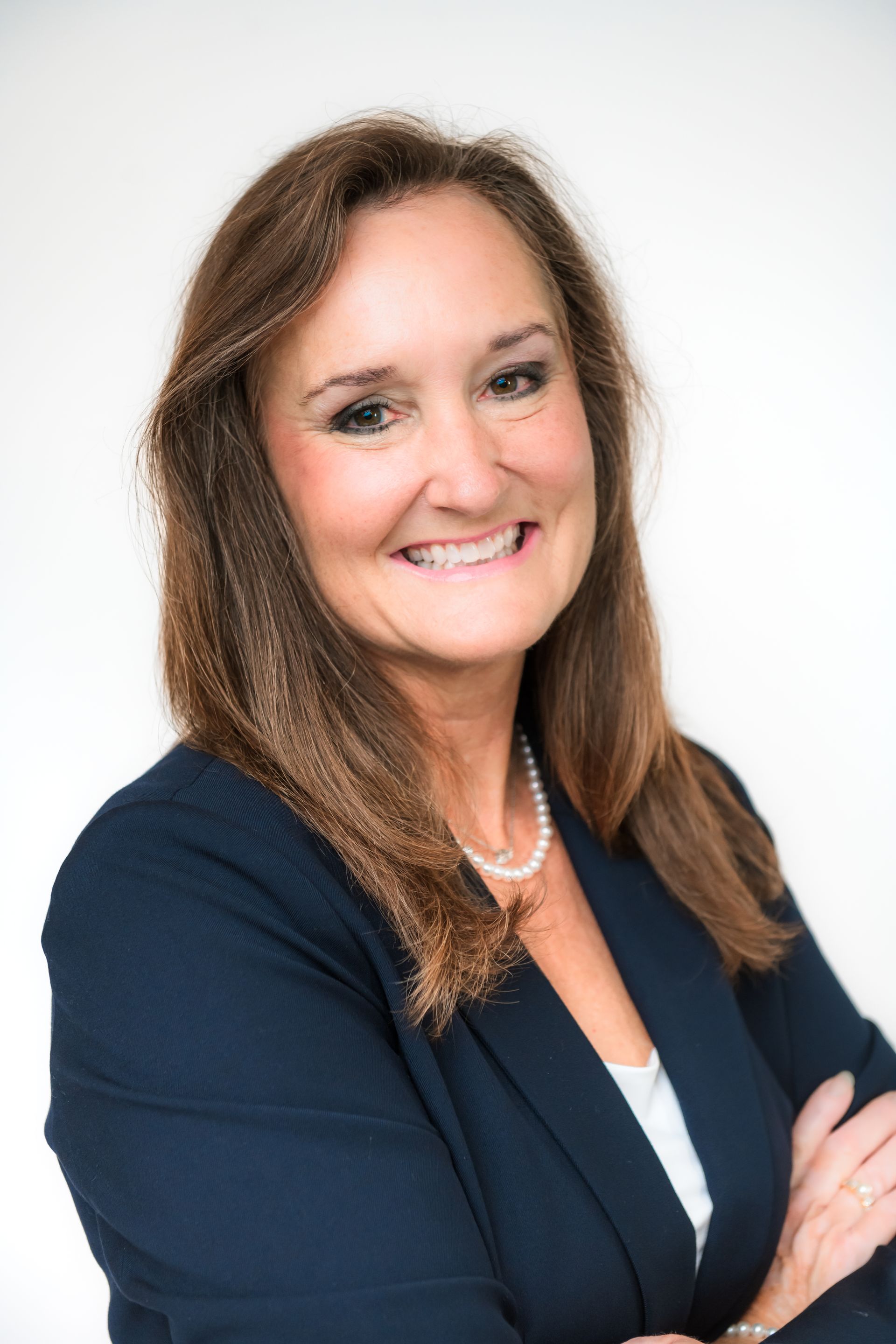  A portrait of a woman, Rebecca, in a blue tank top and pearl necklace, representing individual health insurance in Gulfport.