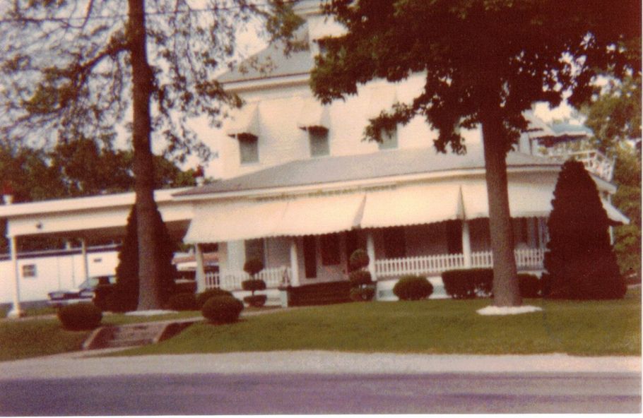 A dignified funeral home director at a mahogany desk