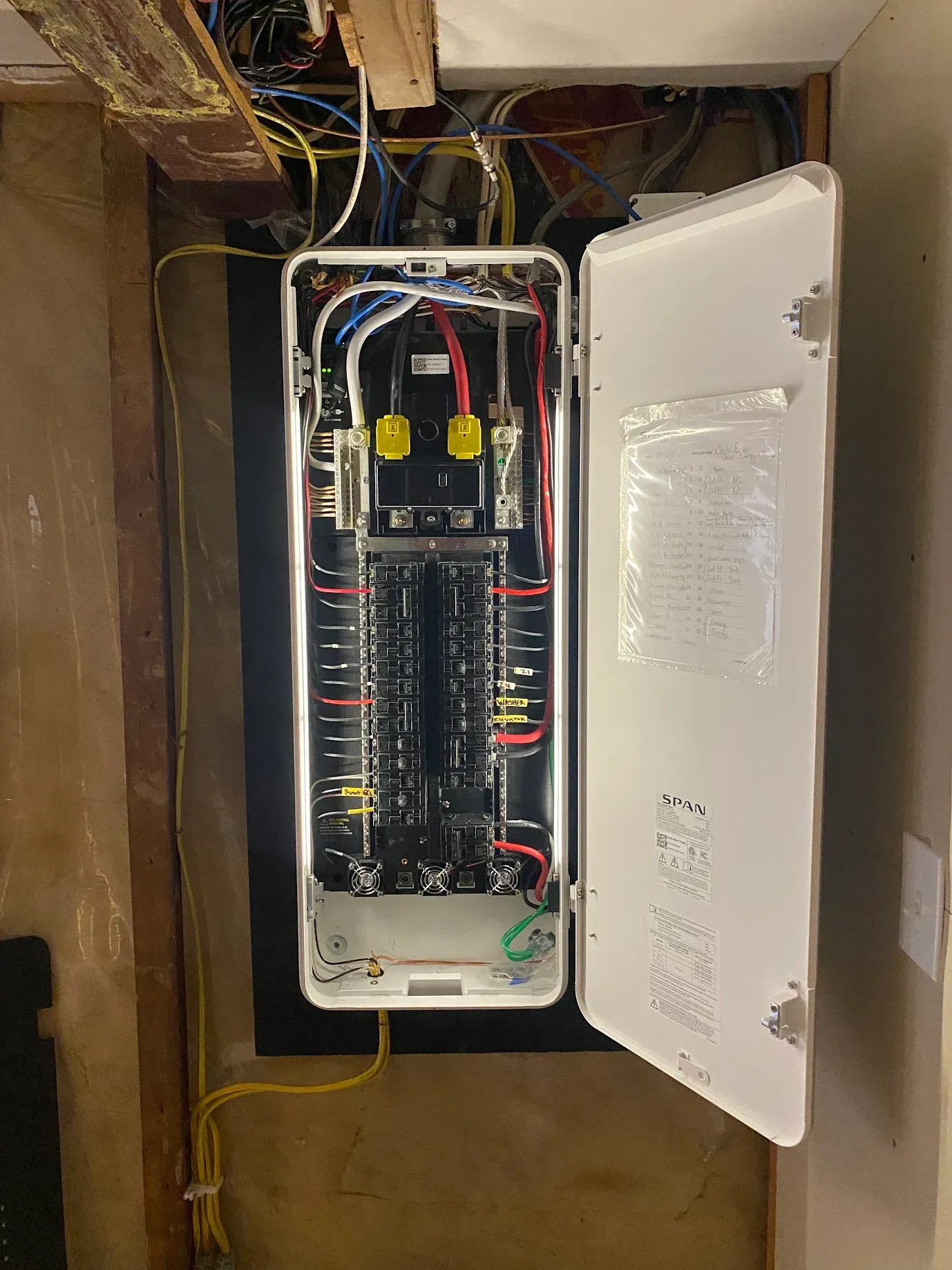 A electrical box with the lid open and a bunch of wires coming out of it.