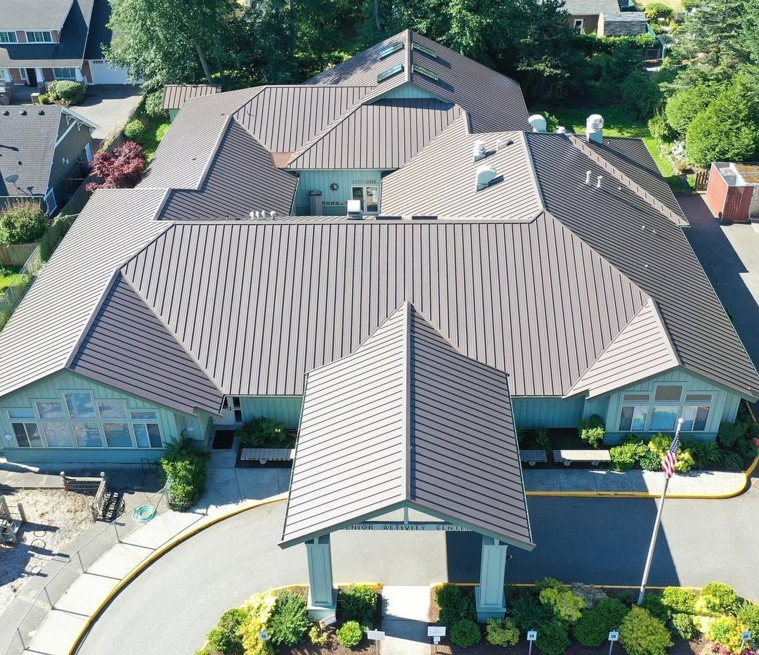 An aerial view of a large building with a metal roof