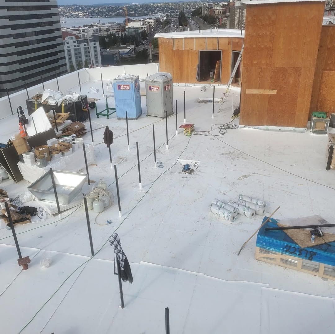 An aerial view of a roof with a few portable toilets on it