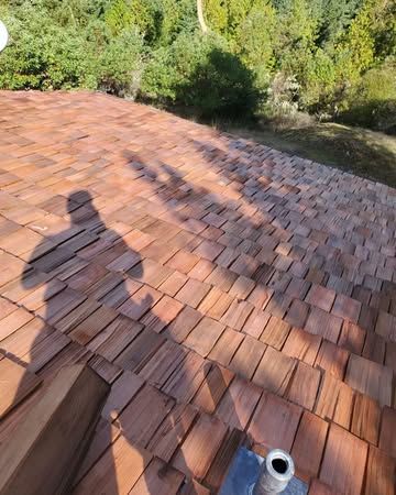 A wooden roof with a shadow of a person on it.