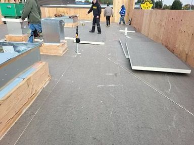 A group of people are working on a roof.