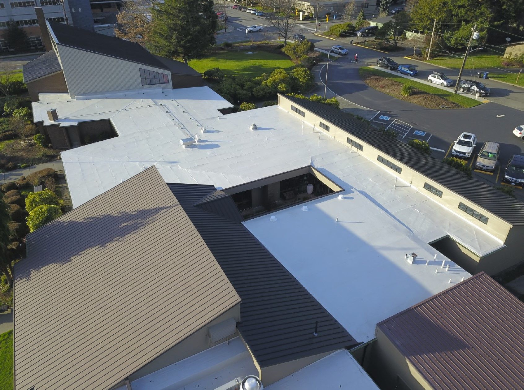 An aerial view of a building with a white roof.