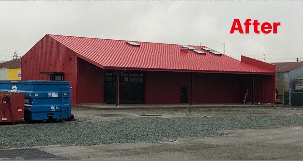 A picture of a building after being remodeled, with a red roof and the word 