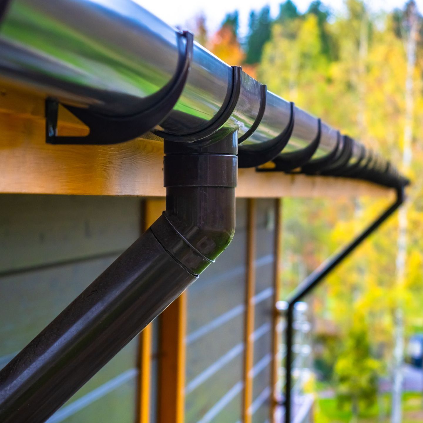 A close up of a half-round gutter on the side of a house.