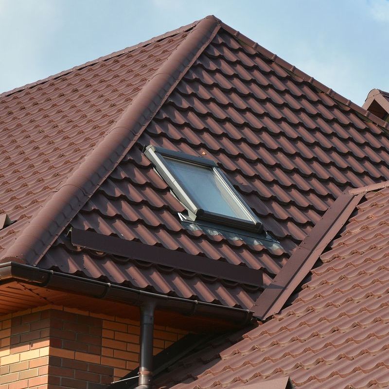 A brown roof with a fixed skylight on it