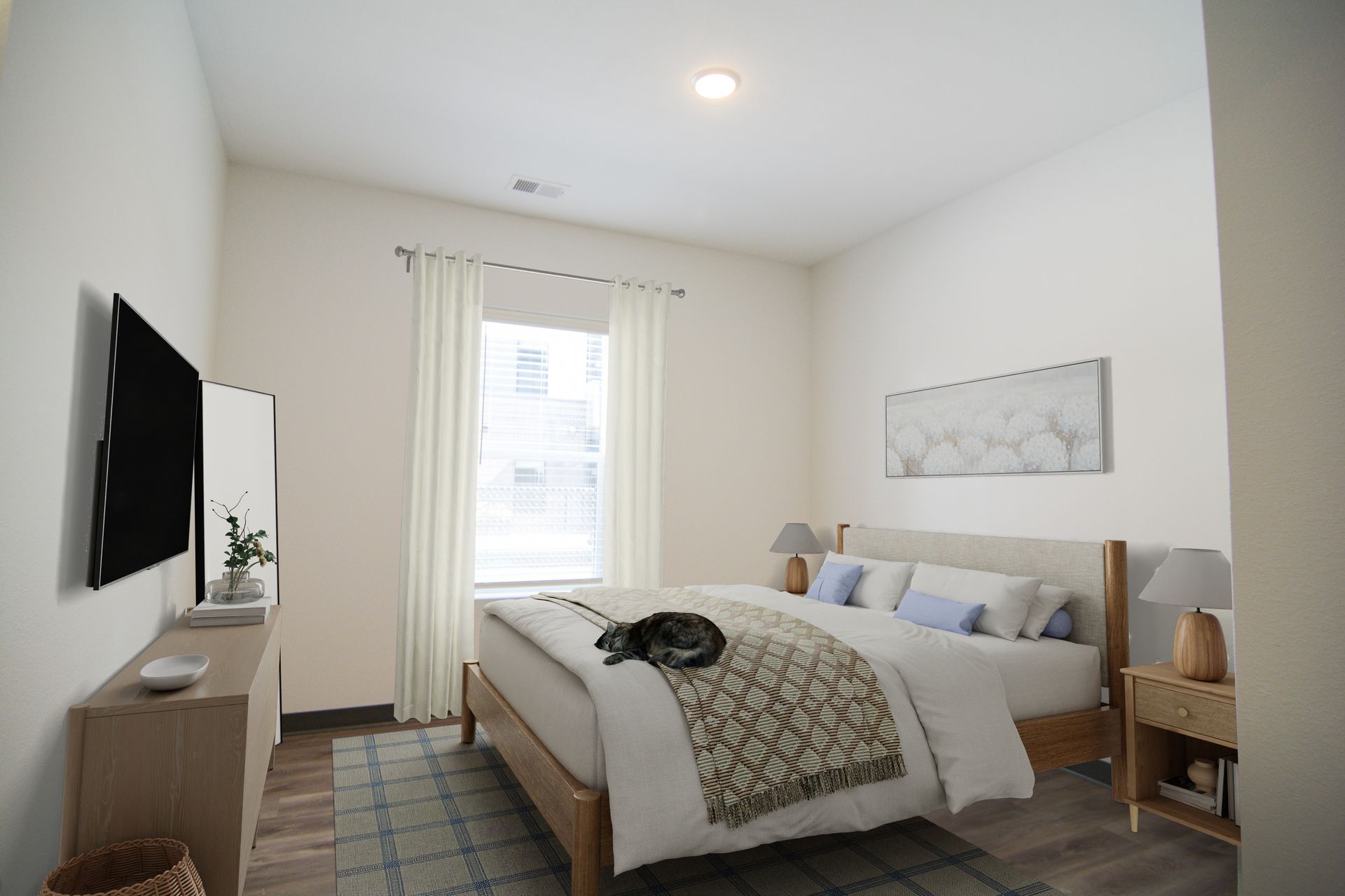 Downtown Lincoln, NE, Affordable Apartments for Rent - Union at Antelope Valley - Bedroom With White Curtains, Nightstands, And A Cat Resting On The Bed.