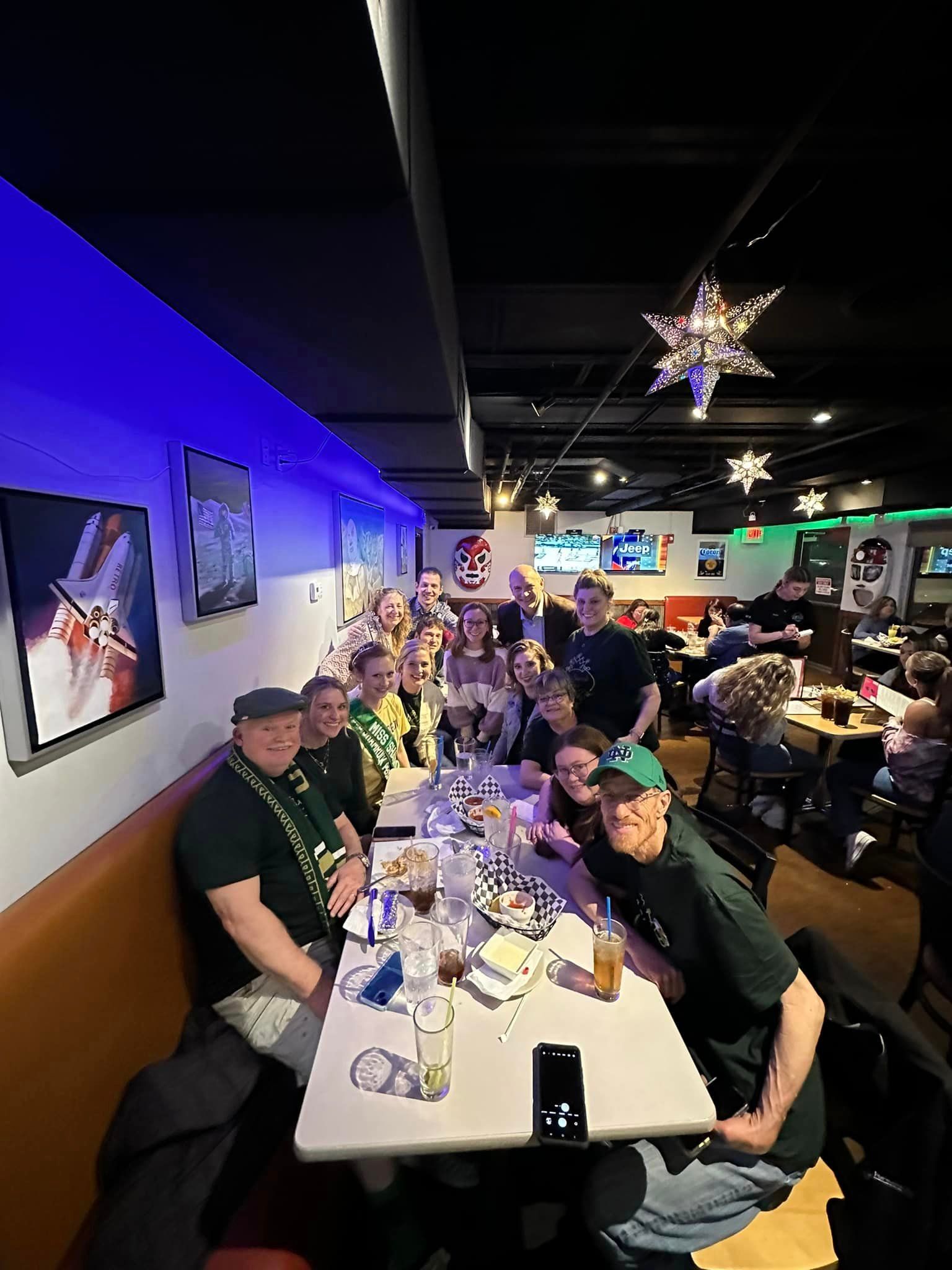 A group of people are sitting at tables in a restaurant