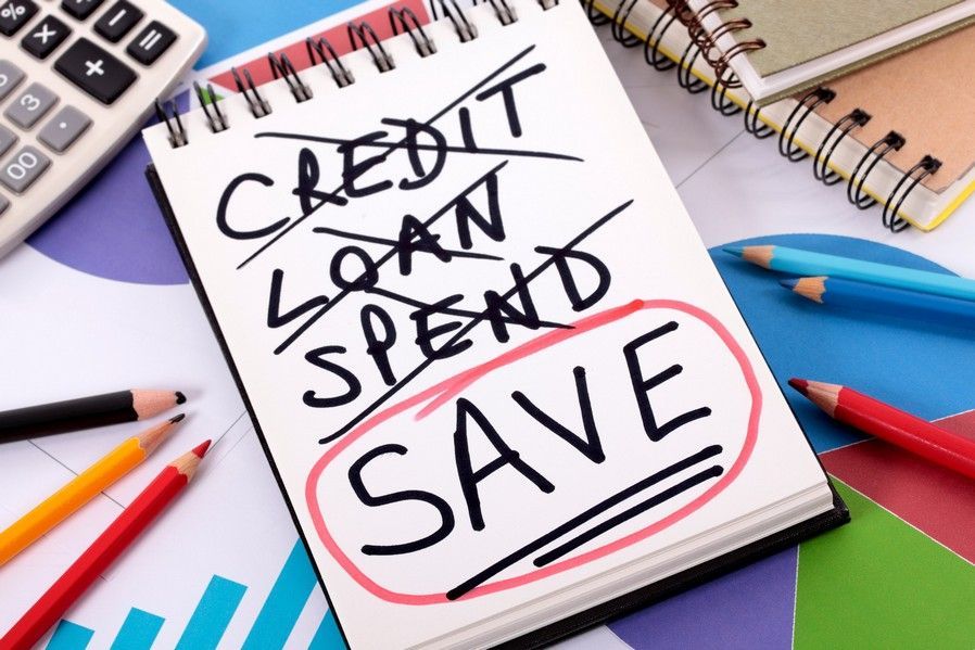A notebook with the words credit loan spend save written on it